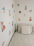 Load image into Gallery viewer, Children's bedroom with woodland animal-themed wall decals on a white wall.