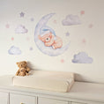 Load image into Gallery viewer, Blue teddy bear sleeping on a crescent moon with clouds and stars on a nursery wall