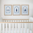 Load image into Gallery viewer, Anchor, lighthouse and sailboat prints displayed above a cot