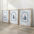 Load image into Gallery viewer, Coastal nursery prints featuring an anchor, lighthouse and sailboat in oak effect frames
