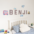 Load image into Gallery viewer, Close view of personalised name fabric wall stickers featuring road-pattern letters with a selection of vehicles