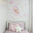 Load image into Gallery viewer, Pink teddy bear moon fabric wall stickers with clouds and stars above a child's bed