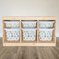 Load image into Gallery viewer, A wooden shelf with six compartments, each containing a white plastic bin with a star pattern design.
