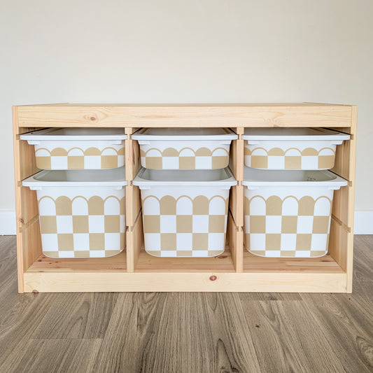 A wooden shelf with six white and tan checkered storage bins arranged in two rows of three.