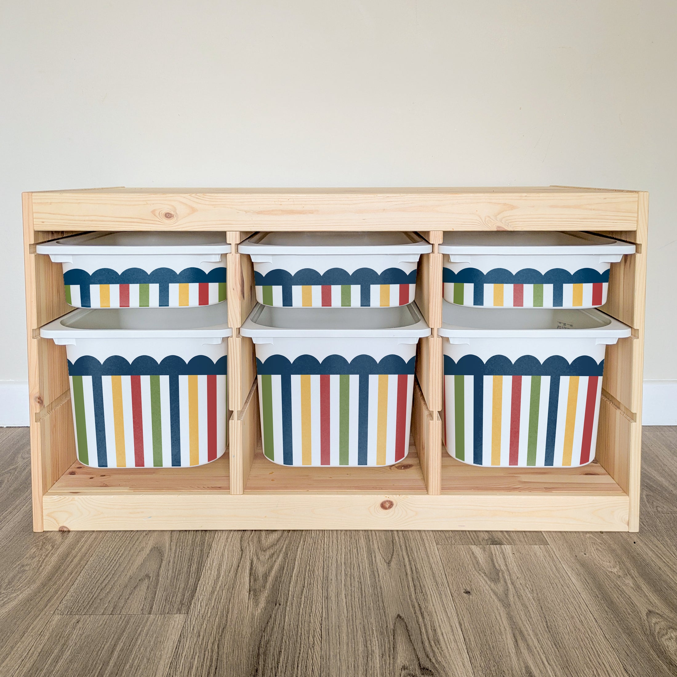 A wooden shelf with six colorful storage bins arranged on it.