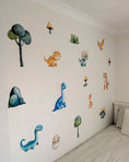 Load image into Gallery viewer, Children's room with dinosaur wall stickers on a white wall.

