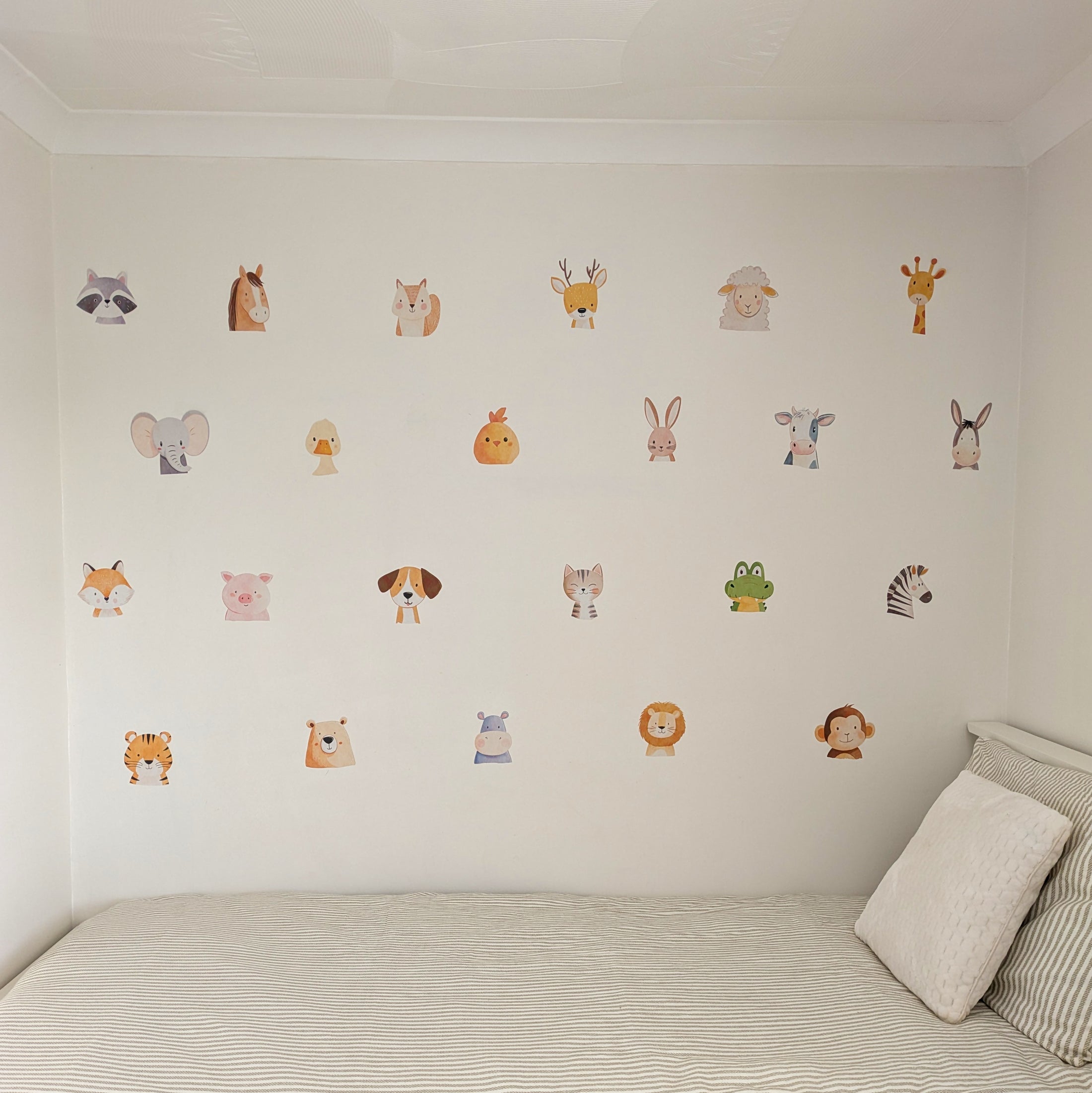 cute animal wall decals above a child's bed