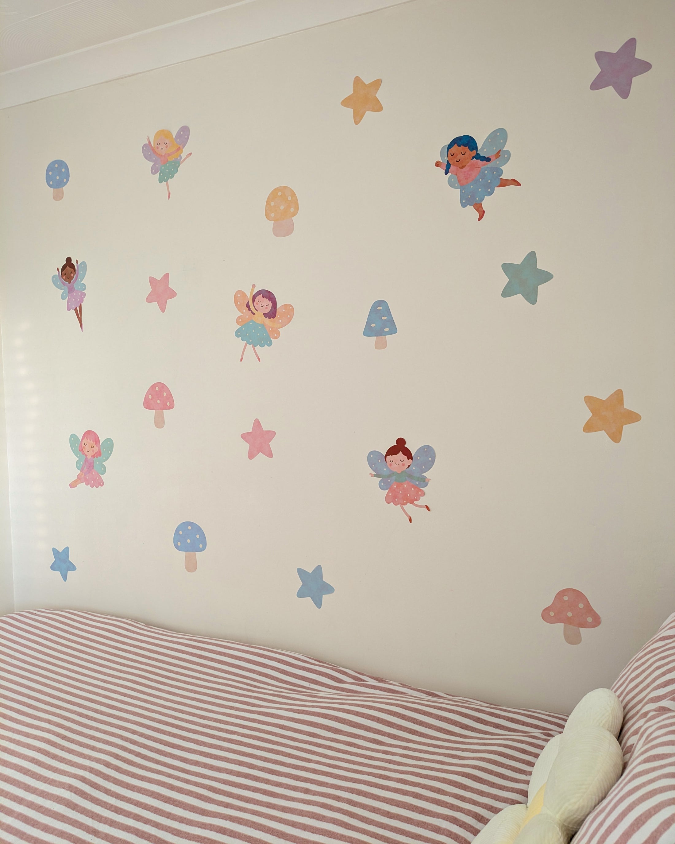 Children's room with fairy and star wall stickers on a white wall.
