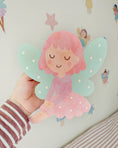 Load image into Gallery viewer, Hand holding a colorful fairy sticker with pink hair and green wings against a light background.
