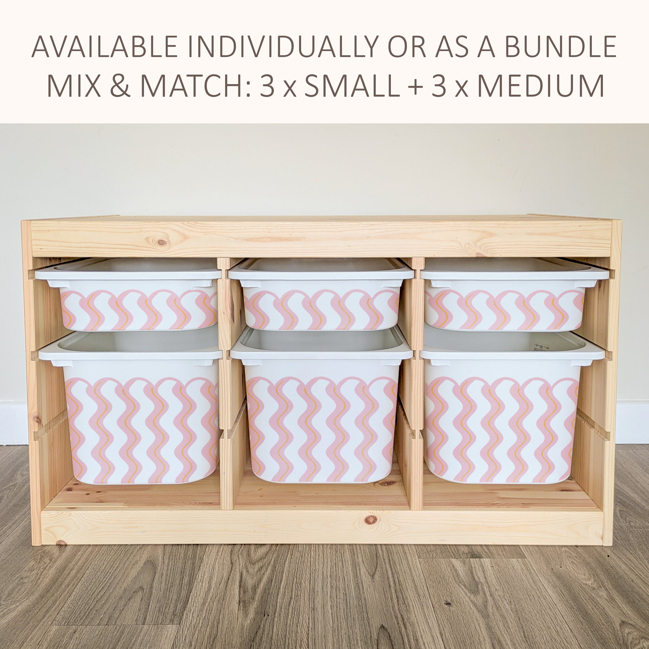 a wooden storage unit with six compartments, each containing a white plastic bin with a pink and white striped pattern. The storage unit appears to be made of wood and has a simple, functional design.