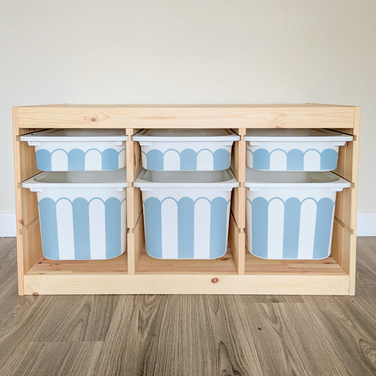 A wooden shelf with six blue and white striped storage bins arranged in two rows of three.