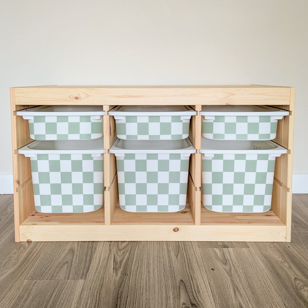 A wooden shelf with six green and white checkered storage bins arranged in two rows of three.