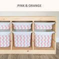 Load image into Gallery viewer, A wooden storage unit with multiple compartments, each containing a pink and orange striped bin.
