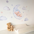 Load image into Gallery viewer, Side view of blue teddy moon wall stickers beside a nursery changing mat
