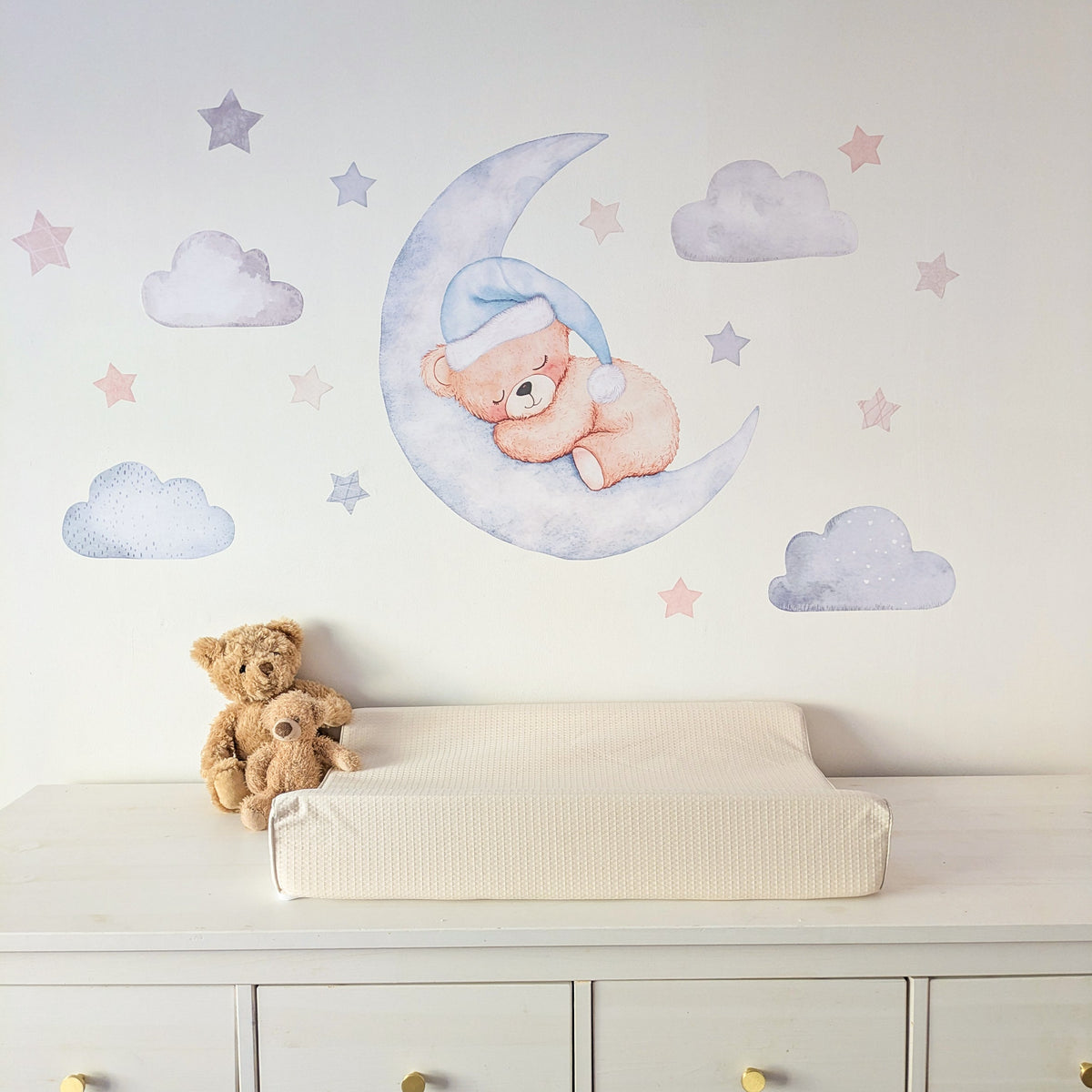 Blue teddy bear moon and stars fabric wall stickers above a nursery changing table