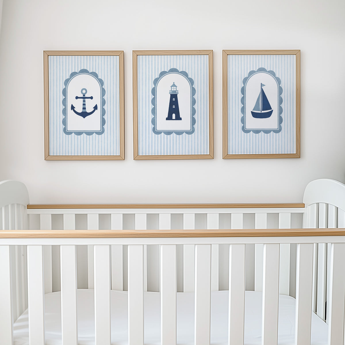 Anchor, lighthouse and sailboat prints displayed above a cot