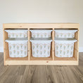 Load image into Gallery viewer, A wooden shelf with six white plastic bins arranged in two rows, each bin featuring a floral pattern.

