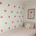 Load image into Gallery viewer, Children's bedroom with heart wall decals and a framed picture on the wall.
