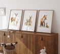 Load image into Gallery viewer, three framed pictures of animals on a wooden cabinet
