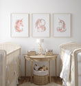 Load image into Gallery viewer, a baby's room with three pictures of unicorns on the wall
