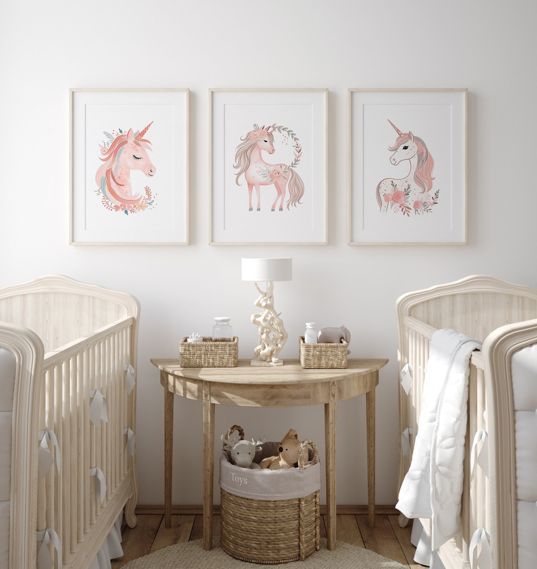 a baby&#39;s room with three pictures of unicorns on the wall