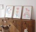 Load image into Gallery viewer, a wooden cabinet with three pictures on top of it
