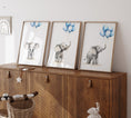 Load image into Gallery viewer, three framed pictures of elephants on a wooden cabinet
