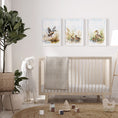 Load image into Gallery viewer, a baby's room with a crib, rocking horse, and two paintings
