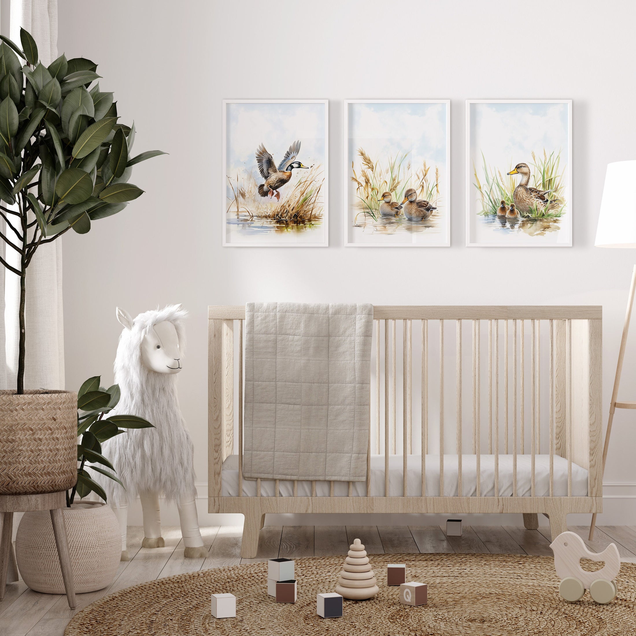 a baby&#39;s room with a crib, rocking horse, and two paintings