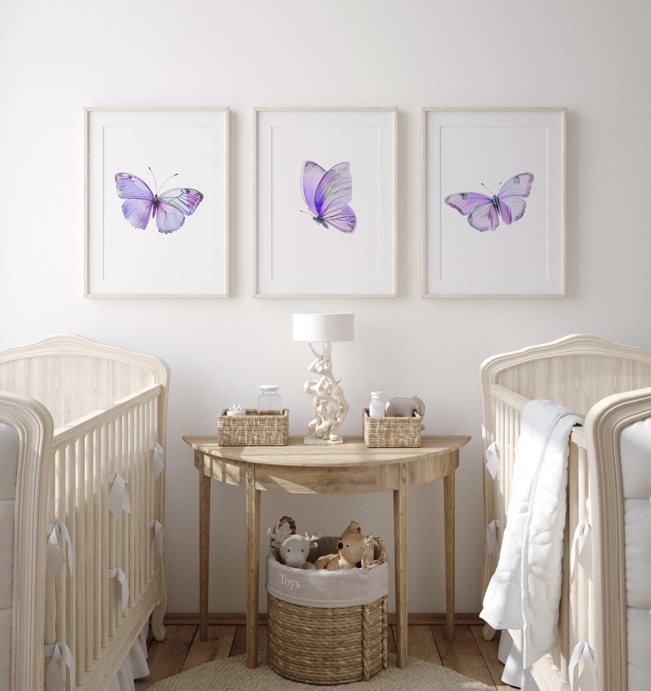 a baby&#39;s room with two cribs and a table
