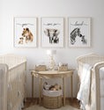 Load image into Gallery viewer, a baby's room with three pictures of animals on the wall
