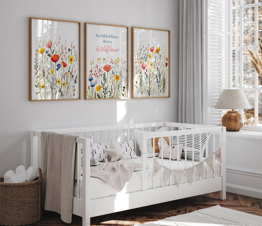 a baby&#39;s room with a white crib and two paintings on the wall