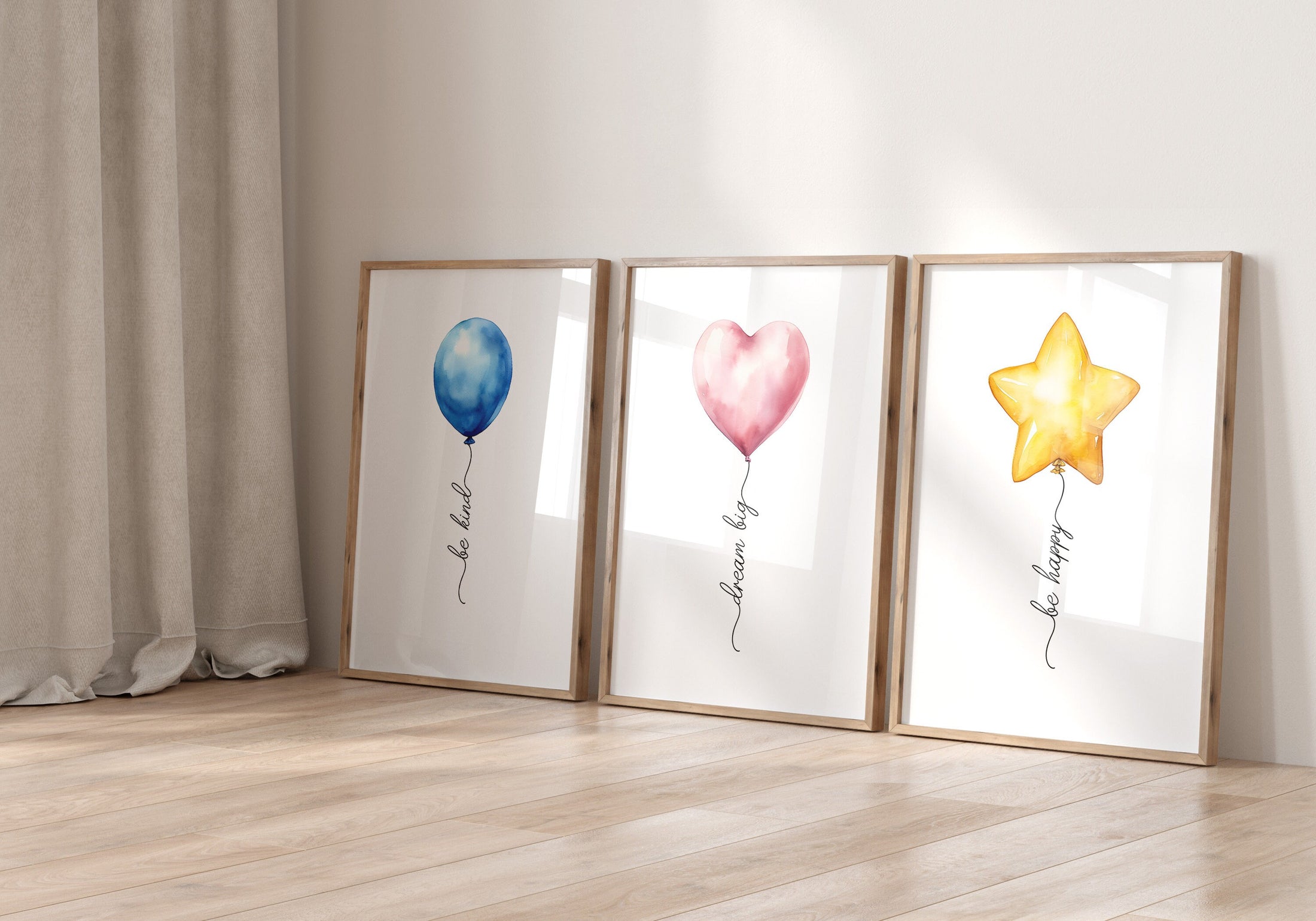 three framed pictures of balloons in a room