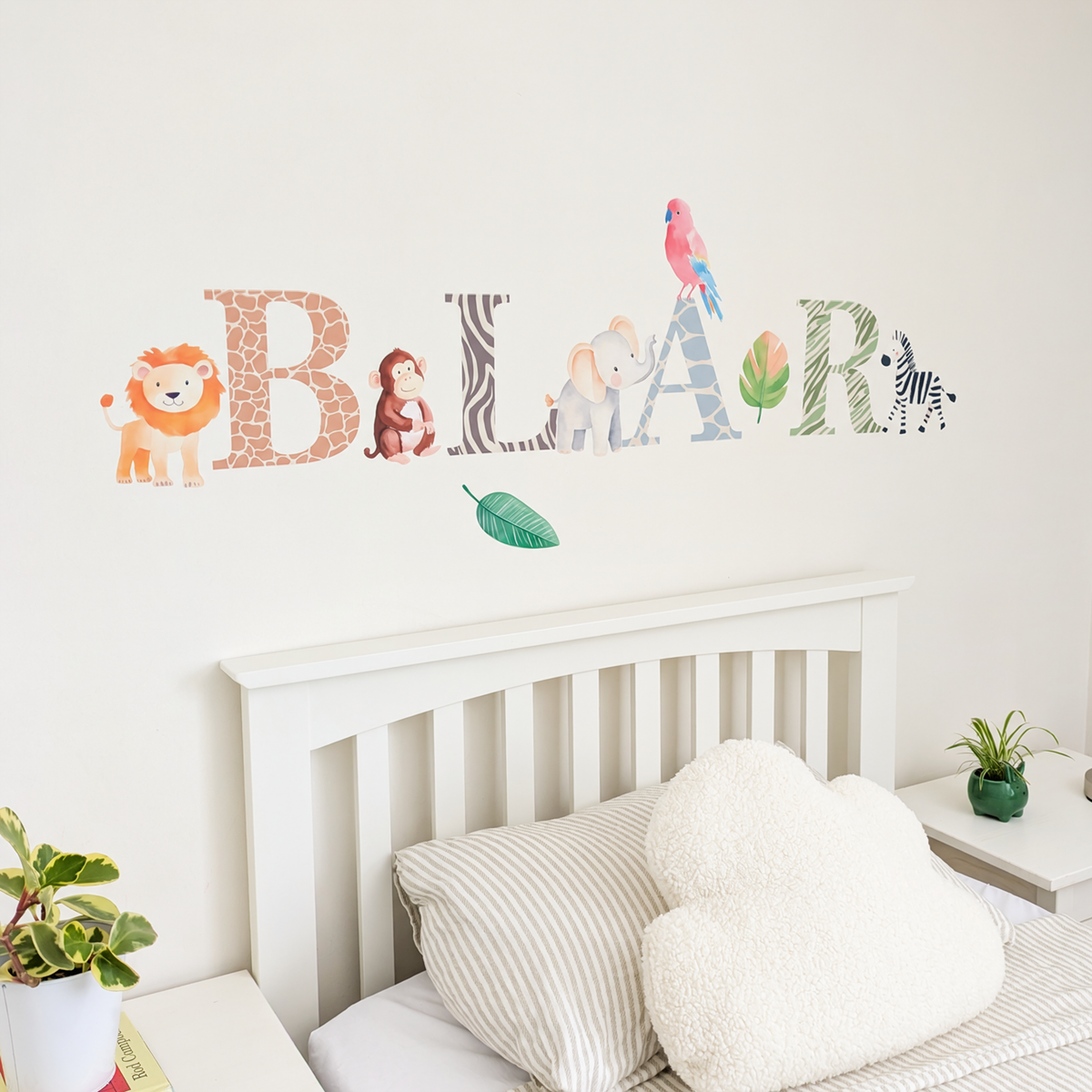 Close view of personalised name fabric wall stickers featuring animal-pattern letters and safari animals