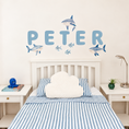 Load image into Gallery viewer, Full display of personalised name fabric wall stickers featuring blue bubble-effect letters with sharks and fish
