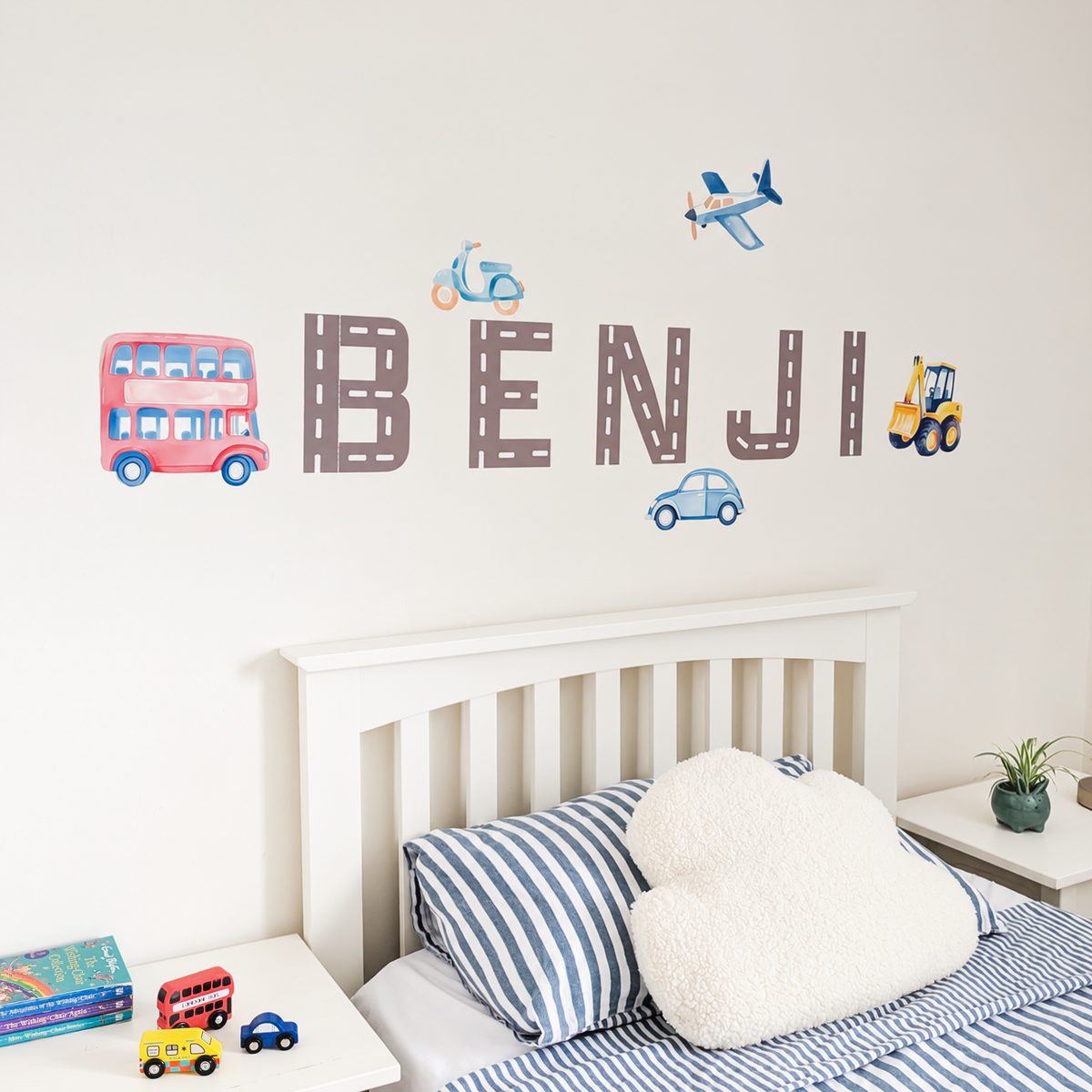 Close view of personalised name fabric wall stickers featuring road-pattern letters with a selection of vehicles