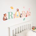 Load image into Gallery viewer, Close view of personalised name fabric wall stickers featuring multicoloured letters with woodland animals and leaves
