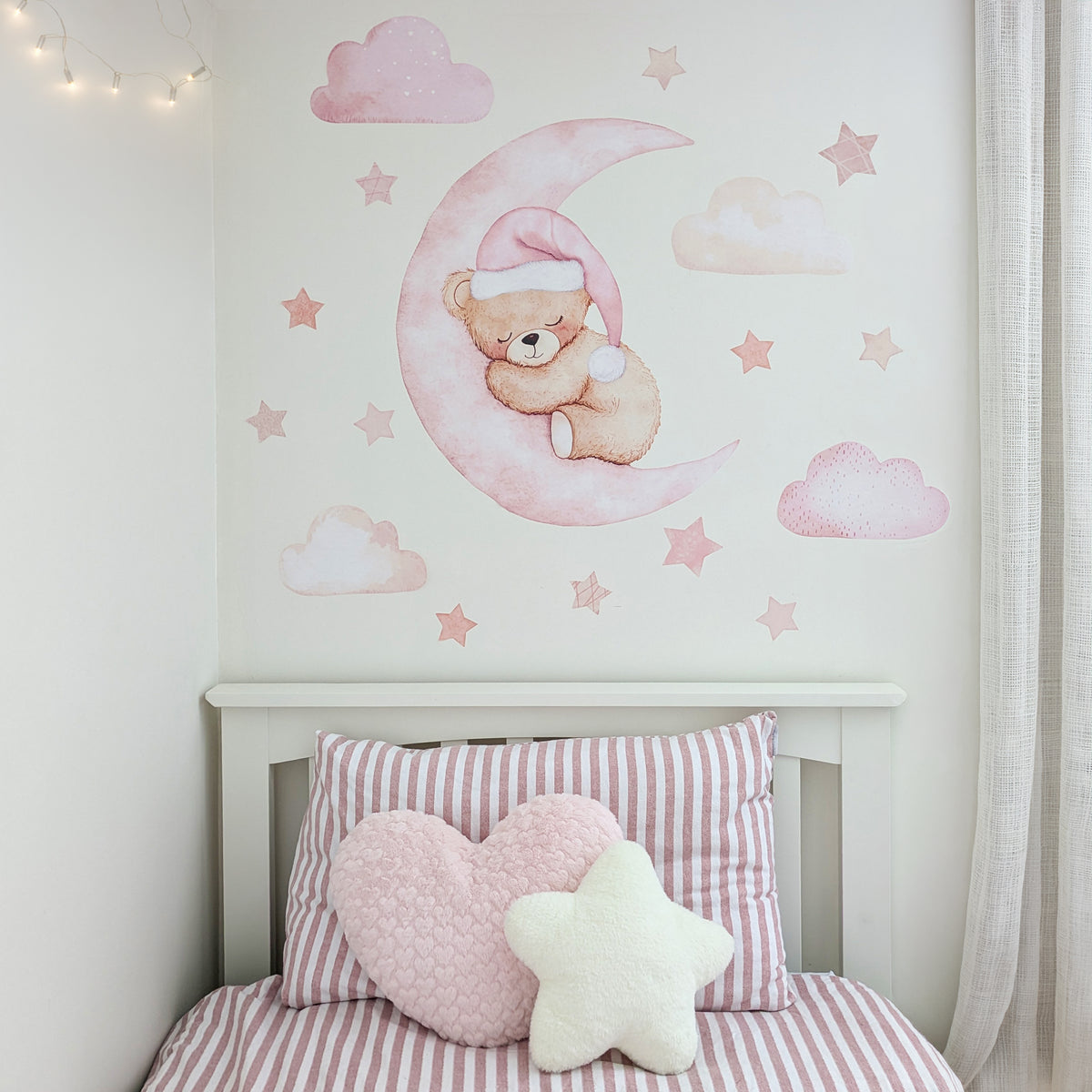 Pink teddy bear moon fabric wall stickers with clouds and stars above a child's bed