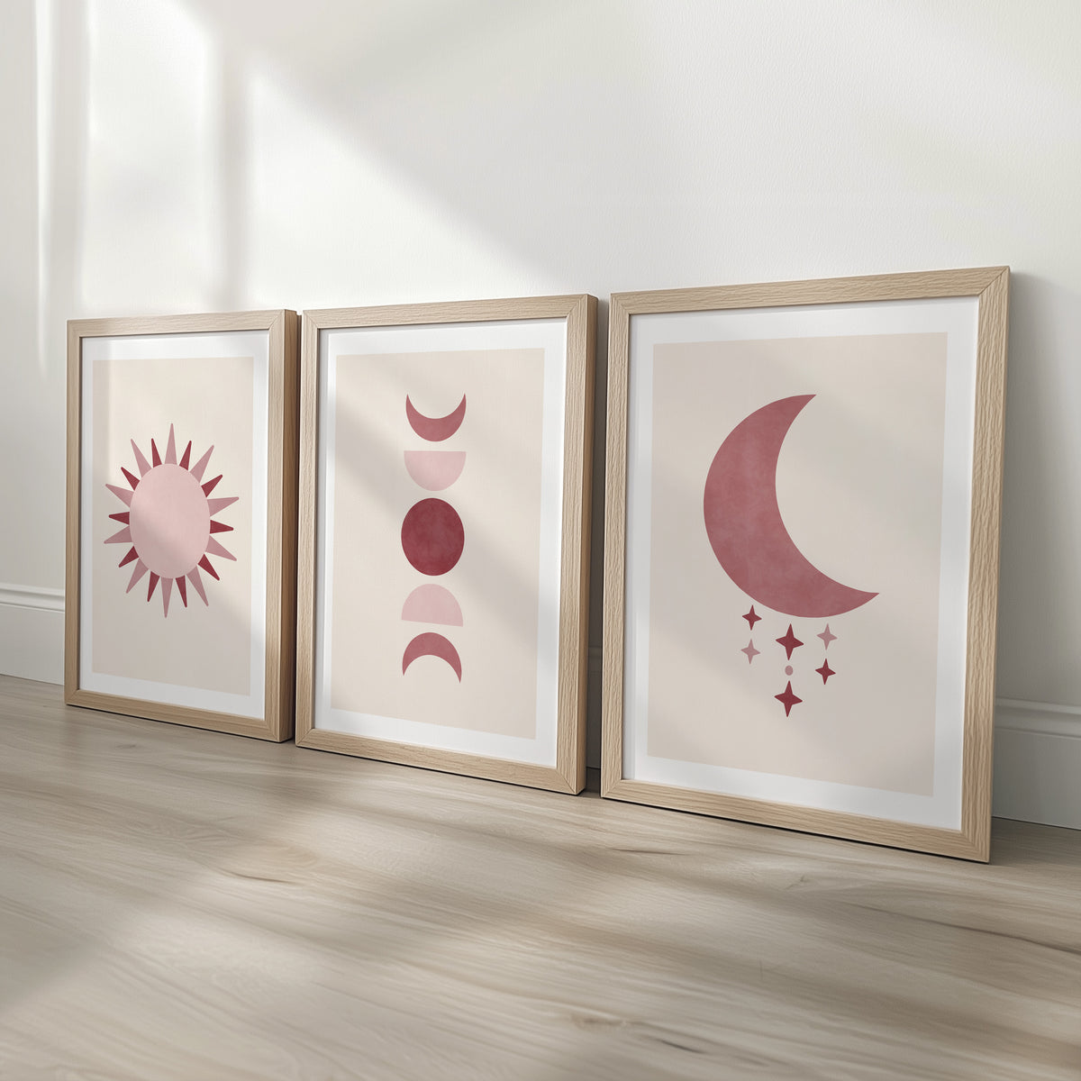 Set of three prints showing rose red sun, moon phases and crescent moon with stars, oak frames display