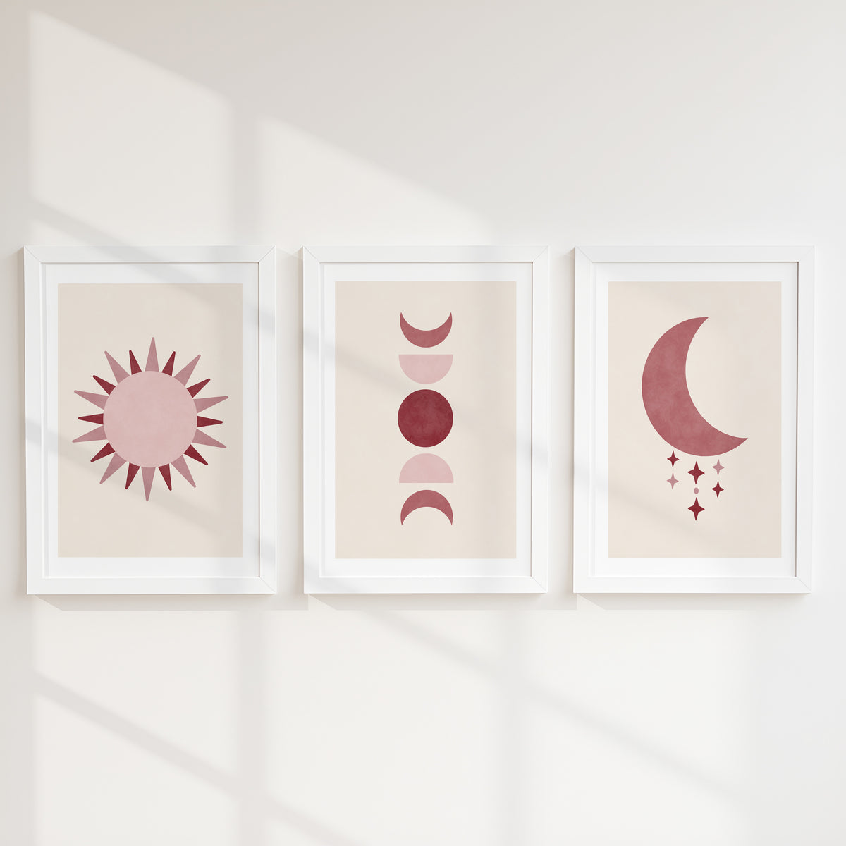 Set of three prints showing rose red sun, moon phases and crescent moon with stars, white frames display