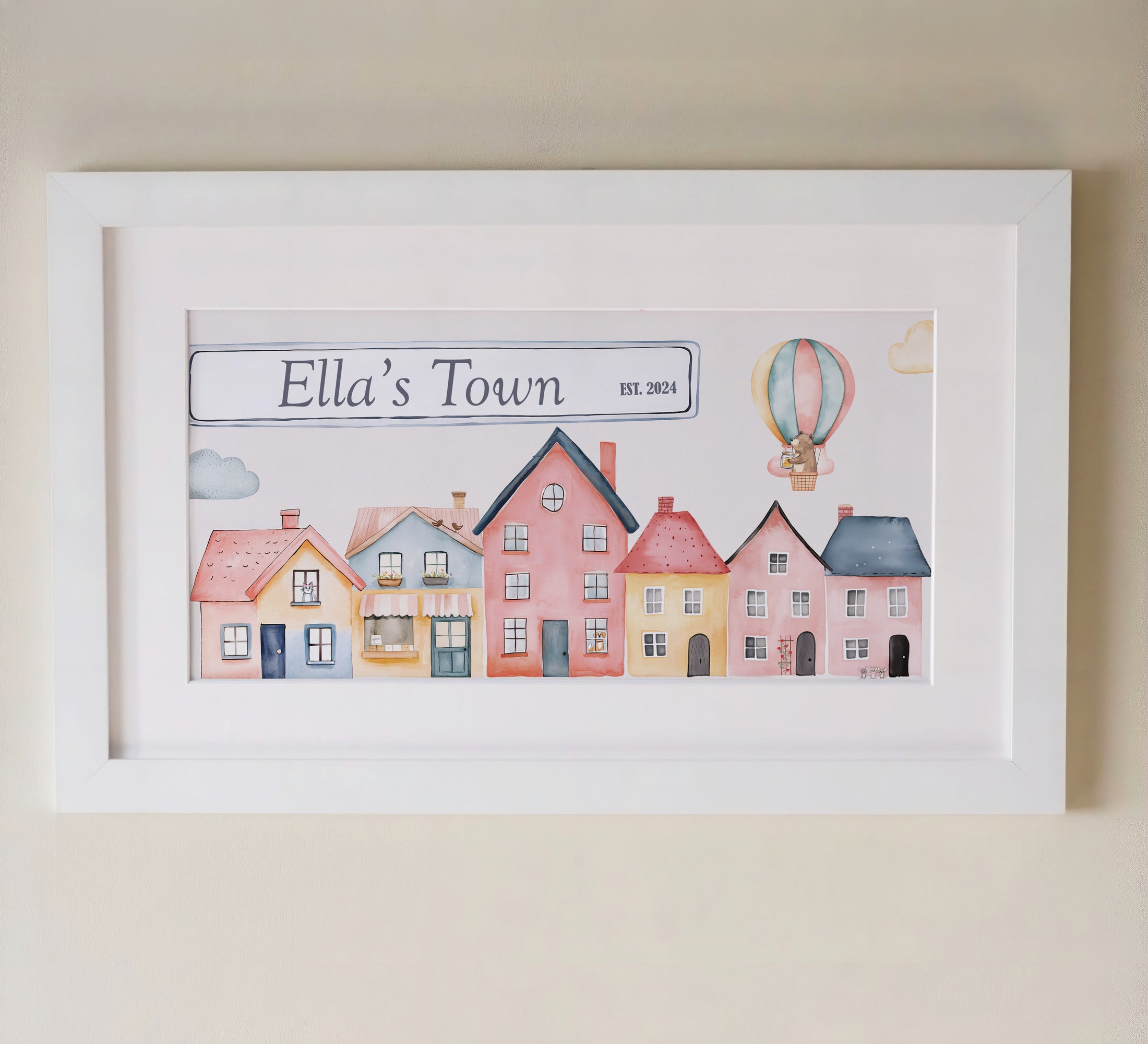 Personalised framed print featuring a charming watercolor design of colourful houses and a hot air balloon in a white frame with mount.