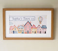 Load image into Gallery viewer, Personalised framed print featuring a charming watercolor design of colourful houses and a hot air balloon in a oak frame with mount.
