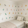 Load image into Gallery viewer, watercolour safari animal decals above a single bed
