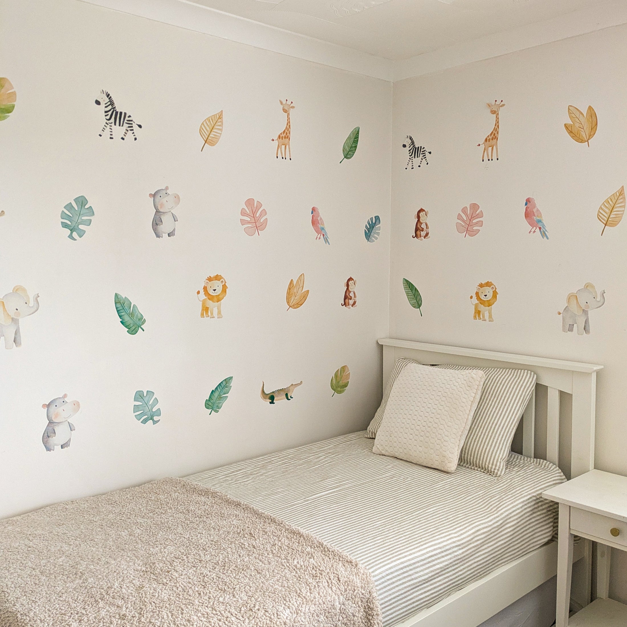 watercolour safari animal decals above a single bed