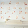Load image into Gallery viewer, Set of 18 sheep fabric wall stickers arranged above a nursery changing table
