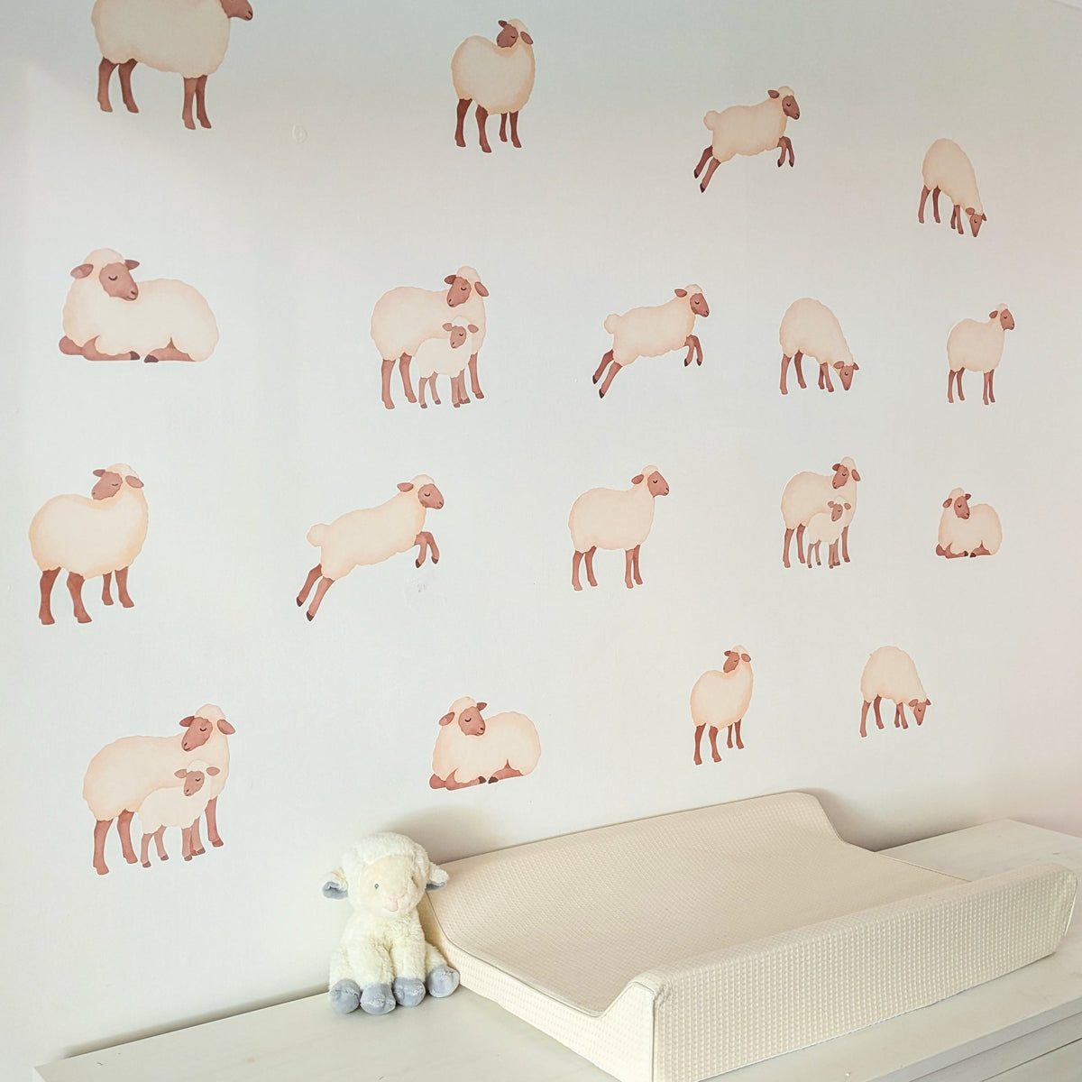 Sheep fabric wall stickers arranged around a nursery changing table