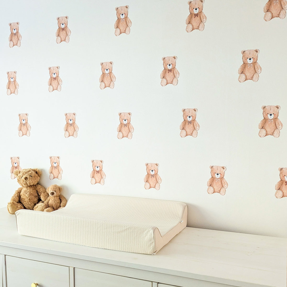 Side view of mini teddy wall stickers arranged in four rows above a changing table